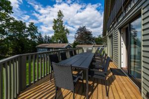 a wooden deck with a table and chairs on it at Alm-Chalet Exclusive 4 in Clausthal-Zellerfeld