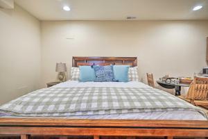 a bedroom with a large bed with blue pillows at Boonsboro Studio with Wood-Burning Fire Pit! in Boonsboro