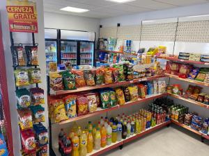 a grocery store aisle with many different types of drinks at Alojamiento El Miajon de los Castúos in Valdesalor