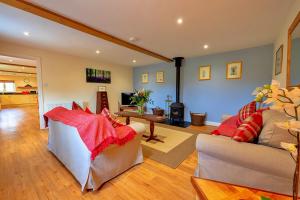 a living room with two couches and a fireplace at Finest Retreats - The Old Granary in Barton Stacey