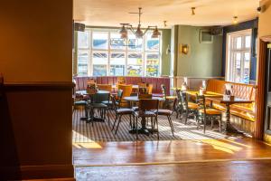 a restaurant with tables and chairs in a room at The Red Lion by Innkeeper's Collection in Portsmouth +17 photos