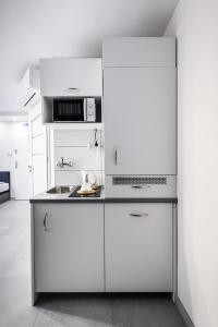 a kitchen with white cabinets and a stove top oven at Magnetic apartment Nowogrodzka B in Warsaw