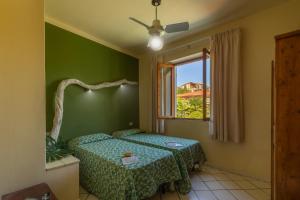 A bed or beds in a room at Hotel Cernia Isola Botanica