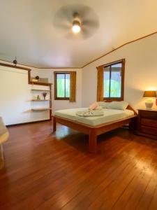 - une chambre avec un lit et un ventilateur de plafond dans l'établissement La Ruka Hostel, à Puerto Viejo