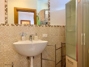 a bathroom with a sink and a mirror at Monolocale Sans Souci 22 in Madonna di Campiglio