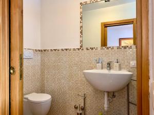 a bathroom with a sink and a toilet and a mirror at Monolocale Sans Souci 22 in Madonna di Campiglio