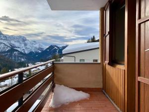 a balcony with a view of a snow covered mountain at Monolocale Sans Souci 22 in Madonna di Campiglio