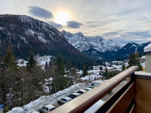 a view of a snow covered mountain with cars parked at Monolocale Sans Souci 22 in Madonna di Campiglio