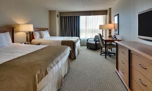 a hotel room with two beds and a desk and a television at Hollywood Casino Gulf Coast in Bay Saint Louis +19 photos