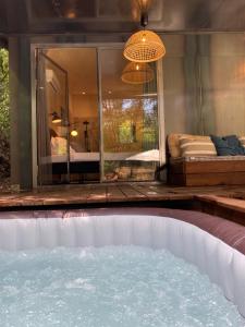 a pool in the middle of a room with a bed at SUBLIME CHALET*JACUZZI*JARDIN*PLANCHA*CLIM*WIFI* in Meyreuil