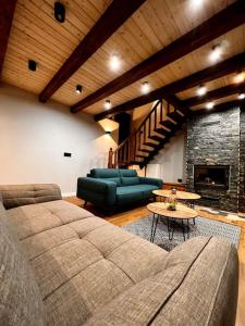 a living room with a couch and a fireplace at Mount House Mavrovo in Mavrovo