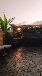 a patio with a bench and a plant on a building at Apartamento un Dormitorio in Valdepeñas