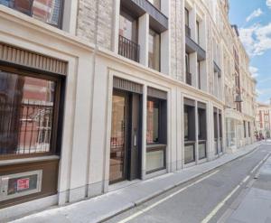 a row of windows on a building on a street at Synergy The Strand in London