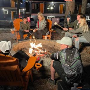 a group of people sitting around a fire pit at The Wanderoo Lodge in Eureka Springs