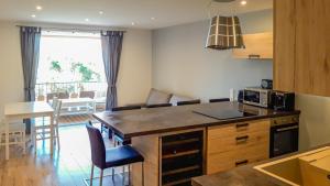 a kitchen with a kitchen island with a counter top at Neptune in Cavalaire-sur-Mer +9 photos