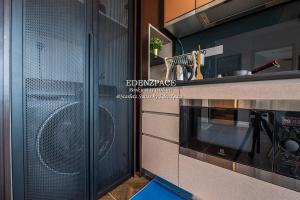 a kitchen with a microwave and a stove at Scarletz Suites by Edenzpace @ KLCC Area in Kuala Lumpur