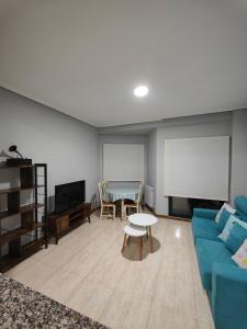 a living room with a couch and a table and a screen at Apartamento Samil Primera Línea de Playa 2F in Vigo