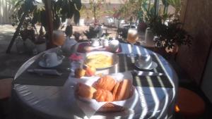 a table with a plate of bread and eggs on it at Bellavista in Lima