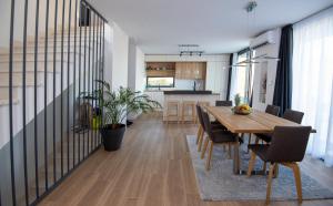 a dining room and kitchen with a table and chairs at Villa Godimento w heated pool in Kučine