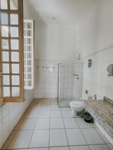 a bathroom with a shower and a toilet in it at NHM Hotel in Araraquara