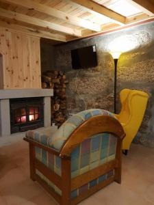 a living room with a couch and a fireplace at Casa Frade in Sabugueiro