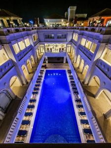 an indoor swimming pool in a building at night at IL Mercato Hotel & Spa in Sharm El Sheikh