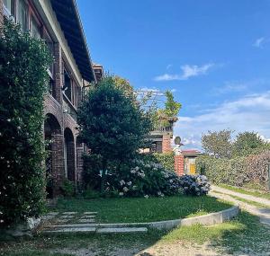 une maison en briques avec un arbre devant elle dans l'établissement Il Gelsomino - Terrace Country House, à Pisano