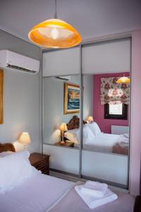 a bedroom with two beds and a large mirror at Villa Valentina in Kala Nera