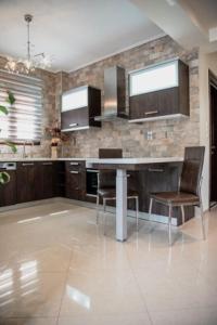 a large kitchen with a table and two chairs at Villa Valentina in Kala Nera
