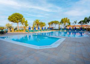 a large swimming pool with blue water in a resort at Le Monde Beach Resort & Spa in Izmir