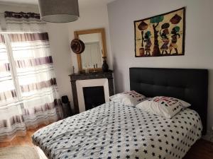 a bedroom with a bed with two pillows on it at Chaleureuse maison de ville à côté de la mairie ronde in Ambert