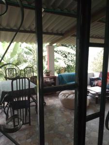 a patio with a table and chairs and a couch at Finca Umnisa - Choachi in Choachí