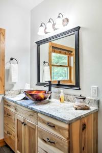 a bathroom with a sink and a mirror at Columbia Falls Apt about 17 Mi to Whitefish Resort! in Columbia Falls