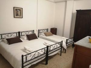two beds are in a room with a counter at Il Sogno in Foligno +4 photos