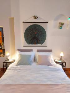 a bedroom with a large white bed with two lamps at Sweet Dreams Suites Cosy Studio Piata Romana in Bucharest
