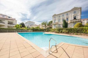 una piscina di fronte a un edificio di Paradise Cannes Center with Pool and Park VILLA LE LYS a Cannes