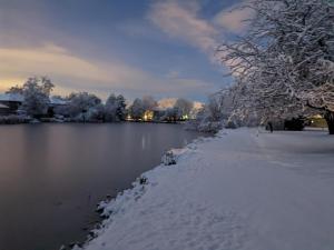 a snow covered path next to a body of water at Lake Front Studio with Kayaks Bikes near Greenbelt in Boise