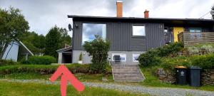 a house with a red arrow pointing at it at Aurora rooms for rent nr2 We are doing privet Northen lights trips, reindeer trip and Fjord sommaroy trip in Tromsø