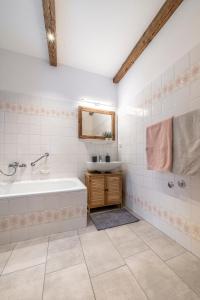 a bathroom with a tub and a sink at Haus Hohenwiesen in Lenggries