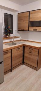 a kitchen with a sink and a christmas tree in it at Bacio-Bacio Apartamenty in Jelenia Góra