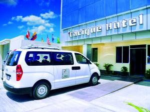 a white van parked in front of a hotel at Cacique Hotel in Piura