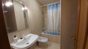 een badkamer met een wastafel, een toilet en een douche bij Apartamento Samil Primera Línea de Playa 2M in Vigo