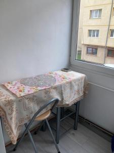 a table with a table cloth on it next to a window at Strand Apartament in Sibiu
