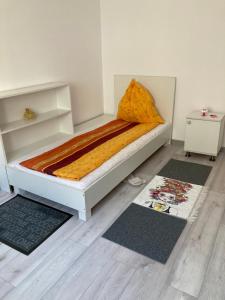 a bed in a room with two rugs at Strand Apartament in Sibiu