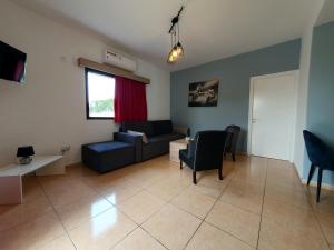 a living room with a couch and a table at Valentina Apartments in Paphos City