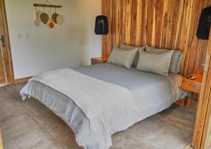 a bedroom with a large bed with wooden walls at Panorama Salento by DOT Boutique in Salento