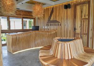a lobby with wooden chairs and a laptop on the wall at Panorama Salento by DOT Boutique in Salento