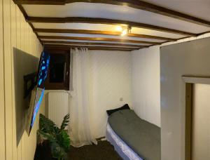 ブリュッセルにあるWell-equipped & simple roomのベッドと窓が備わる小さな客室です。