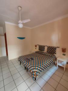 um quarto com uma cama e uma ventoinha de tecto em Estoril Hotel - Apartments em Sal Rei
