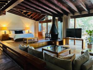 a large living room with a bed and a couch at Villa Tatala hotel boutique in Tepoztlán